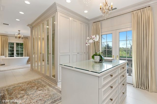 a kitchen with kitchen island granite countertop a refrigerator and a sink