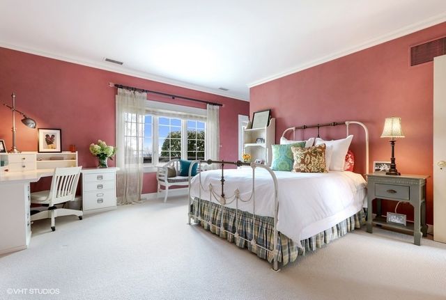 a bed room with a bed and a chair