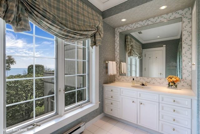 a spacious bathroom with a double vanity sink a mirror and a shower