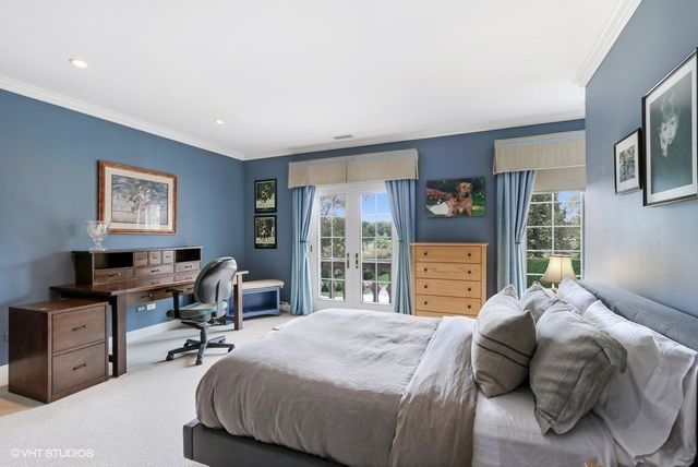 a bedroom with a bed and a desk