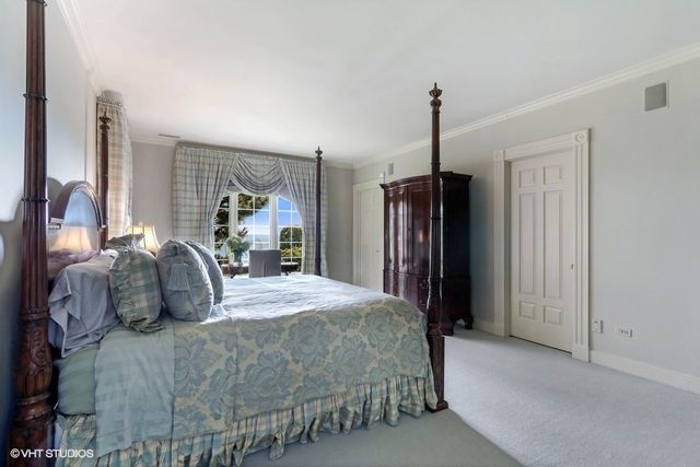 a bedroom with a bed window and a walk in closet