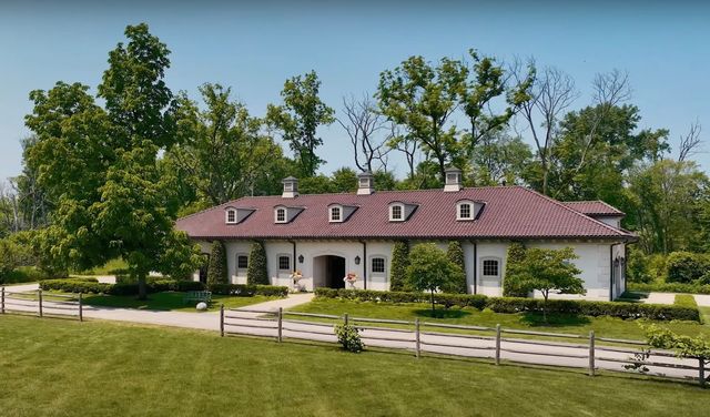 a front view of a house with a yard table and chairs