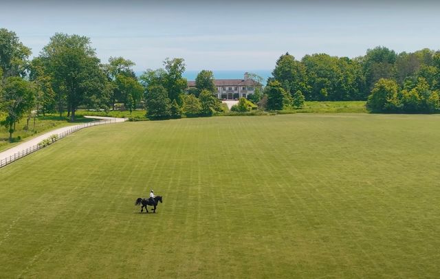 a view of a house with a yard and a fountain