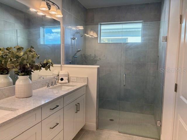 7408 Wing Span Way Harmony, FL 34773 - Photo 12 of 30 a bathroom with a shower sink and mirror