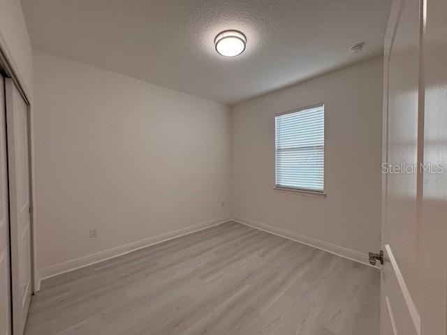 7408 Wing Span Way Harmony, FL 34773 - Photo 15 of 30 wooden floor in an empty room with a window