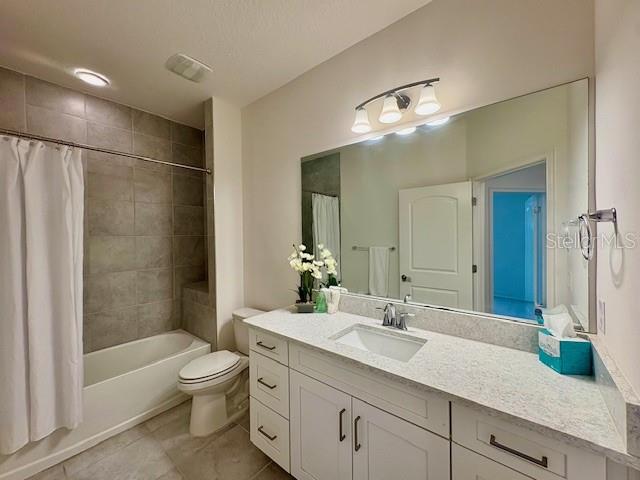 7408 Wing Span Way Harmony, FL 34773 - Photo 16 of 30 a bathroom with a sink vanity granite toilet and shower