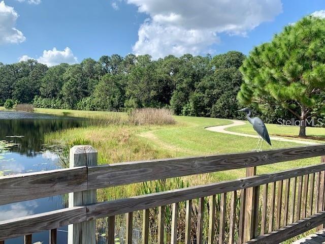 7408 Wing Span Way Harmony, FL 34773 - Photo 26 of 30 a view of a lake with a yard