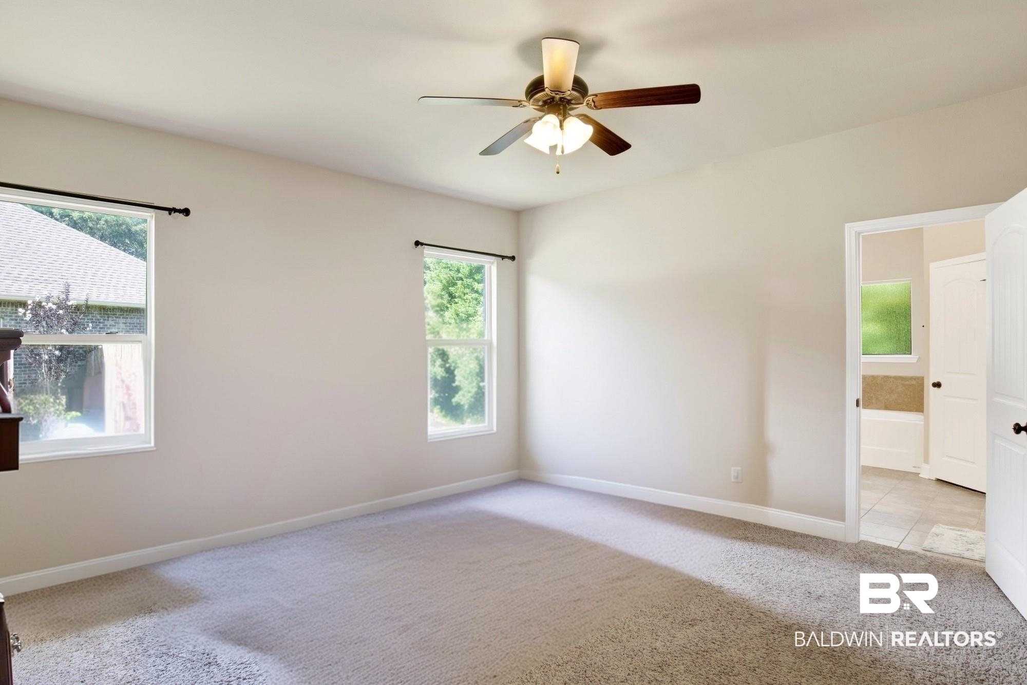 21282 Merlot Loop Silverhill, AL 36576 - Photo 16 of 27 Carpeted empty room featuring a healthy amount of sunlight and ceiling fan
