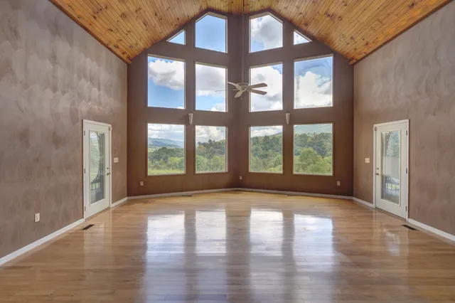 a large kitchen with granite countertop a sink and white cabinets