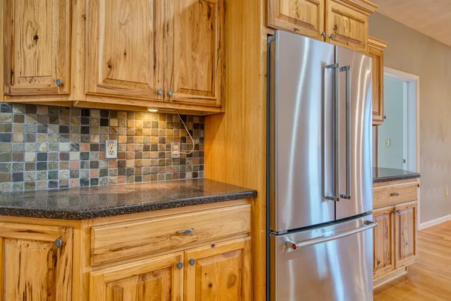 a kitchen with a sink a window and wooden floor