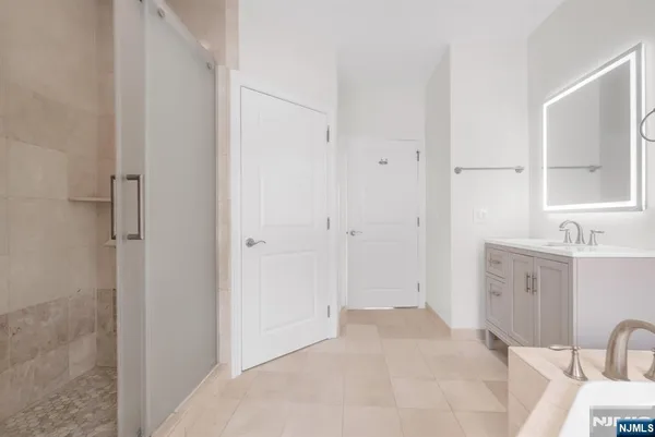 a spacious bathroom with a granite countertop sink and a mirror