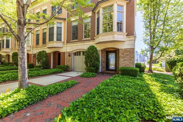 front view of a brick house with a yard