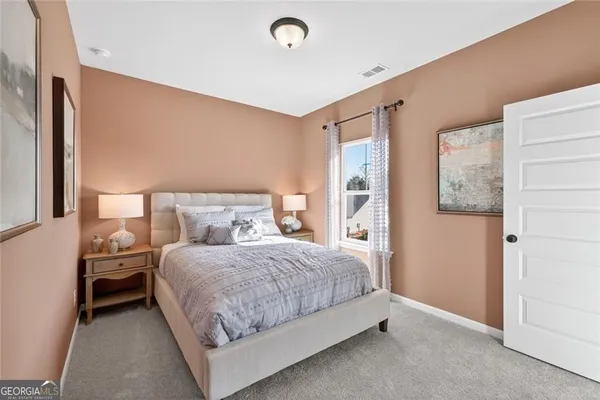 a en suite bathroom with a sink mirror and toilet