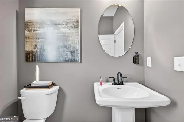 a bathroom with a double vanity sink toilet mirror and shower