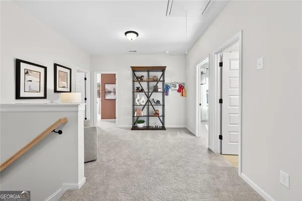 a bedroom with a bed a chandelier and a couch