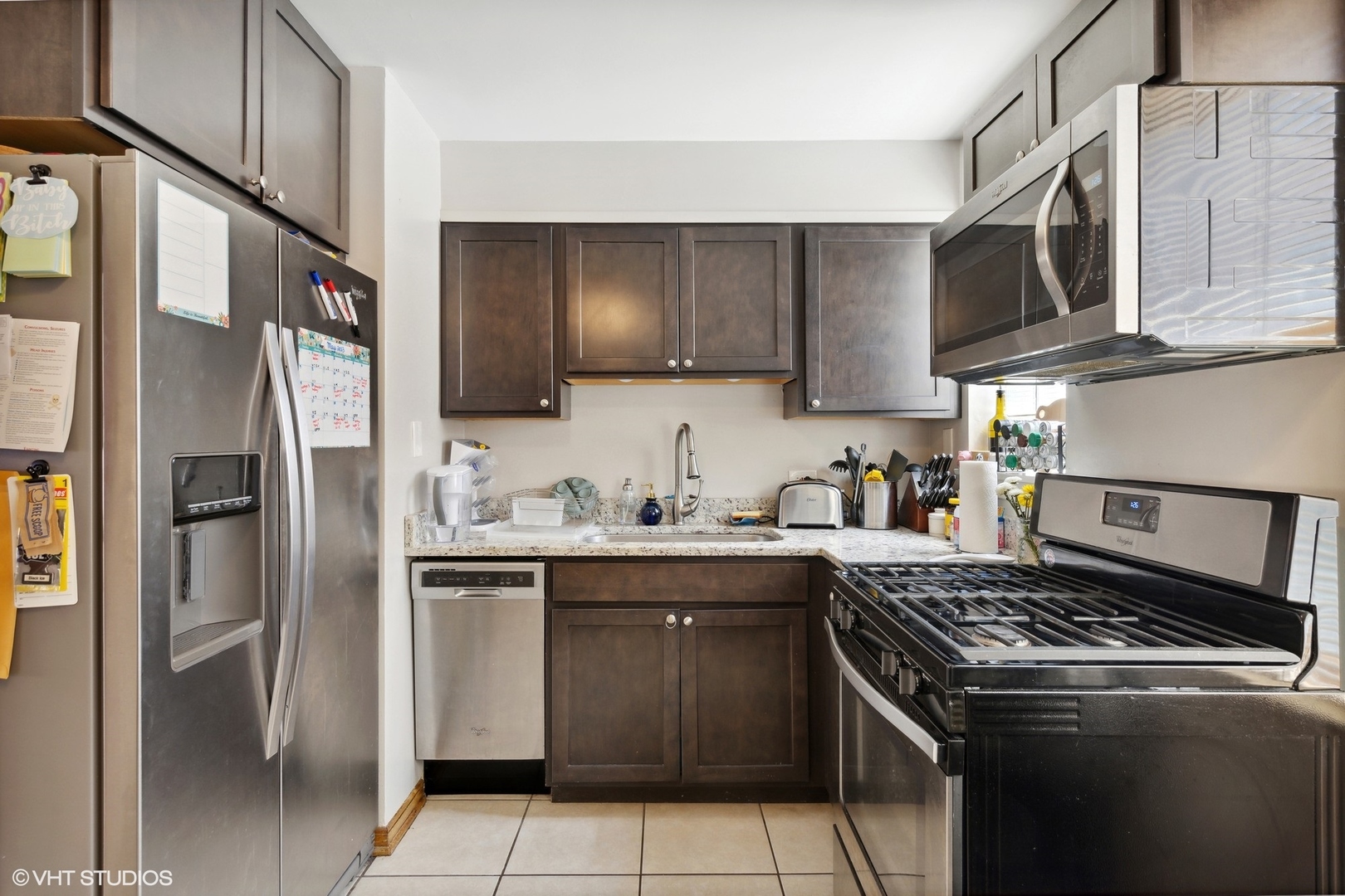 3024 Harlem Avenue Riverside, IL 60546 - Photo 5 of 12 a kitchen with stainless steel appliances granite countertop a stove a refrigerator and a sink