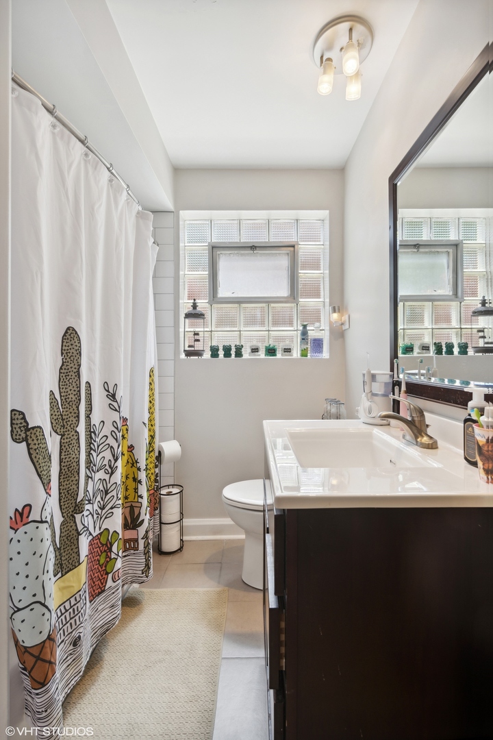 3024 Harlem Avenue Riverside, IL 60546 - Photo 7 of 12 a en suite bathroom with a double vanity sink a mirror and a shower