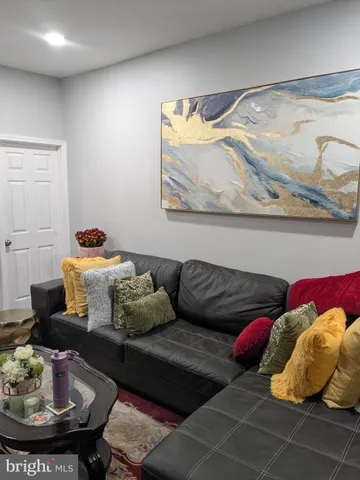 a living room with furniture and a lamp