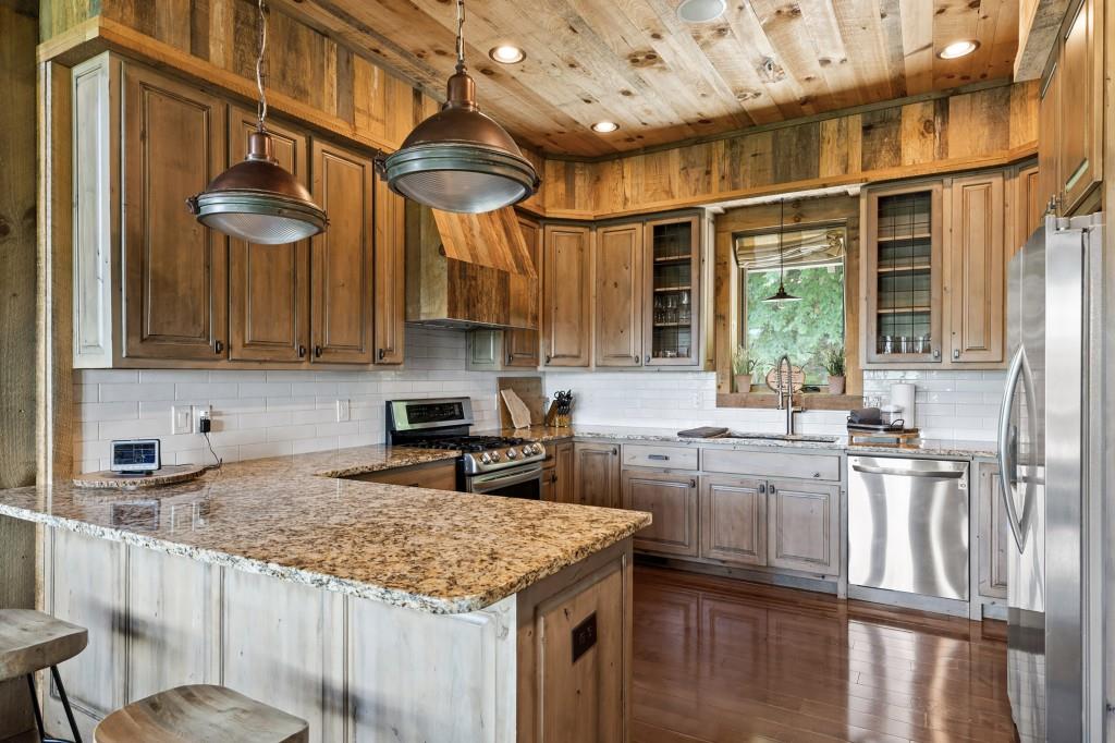 436 Geronimo Road Cherry Log, GA 30522 - Photo 52 of 58 a kitchen with stainless steel appliances granite countertop a sink a stove and a wooden cabinets