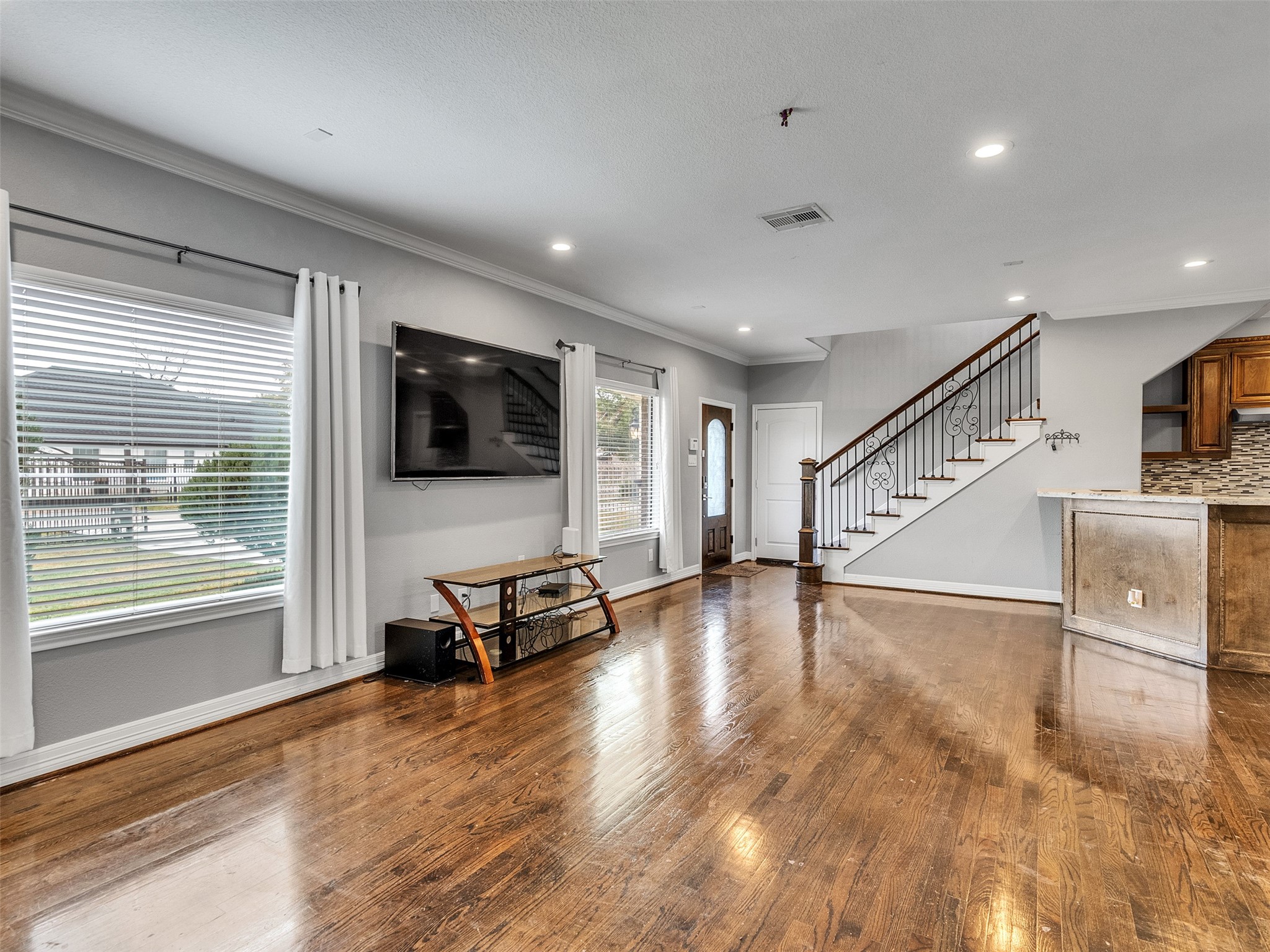 5814 Luna Street Houston, TX 77076 - Photo 11 of 44 a view of a livingroom with furniture a flat screen tv and windows