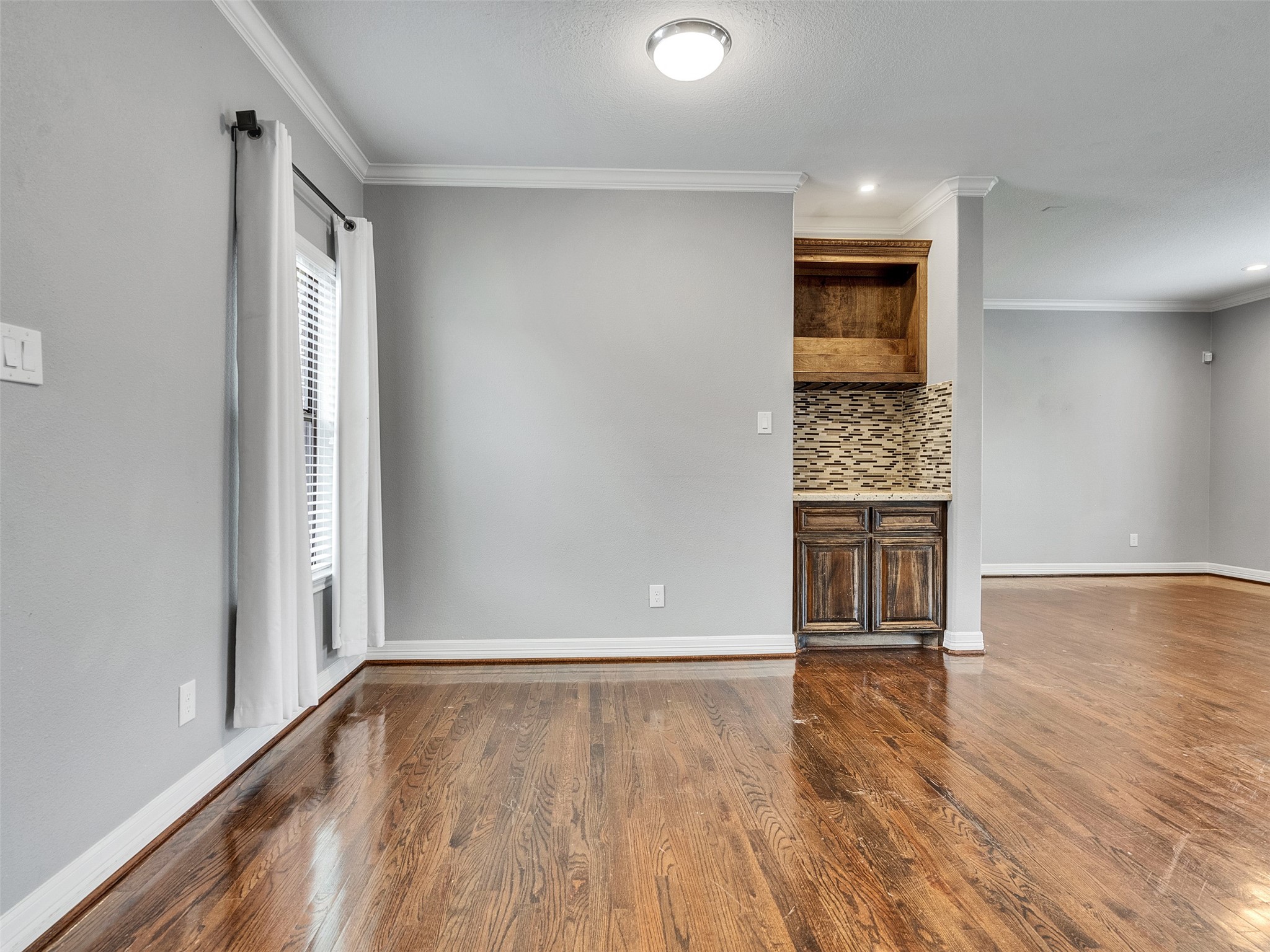 5814 Luna Street Houston, TX 77076 - Photo 13 of 44 wooden floor in an empty room with a window