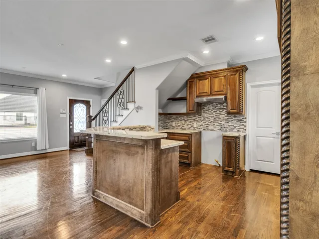 a bathroom with a sink a toilet a mirror and a window