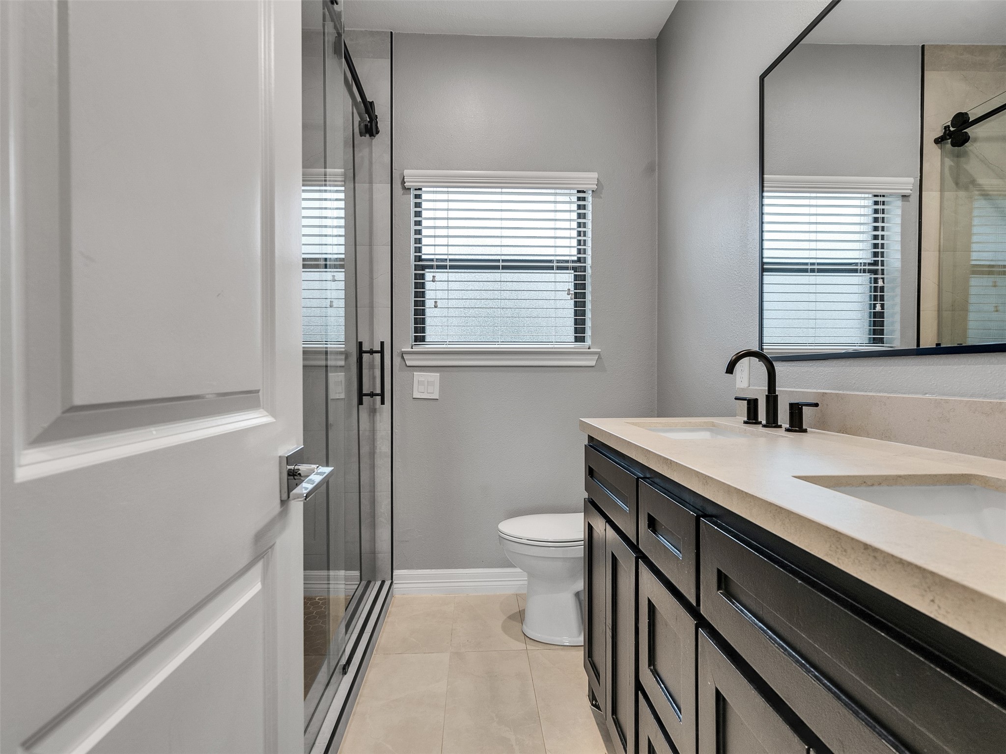 5814 Luna Street Houston, TX 77076 - Photo 18 of 44 a bathroom with a sink a toilet and a window