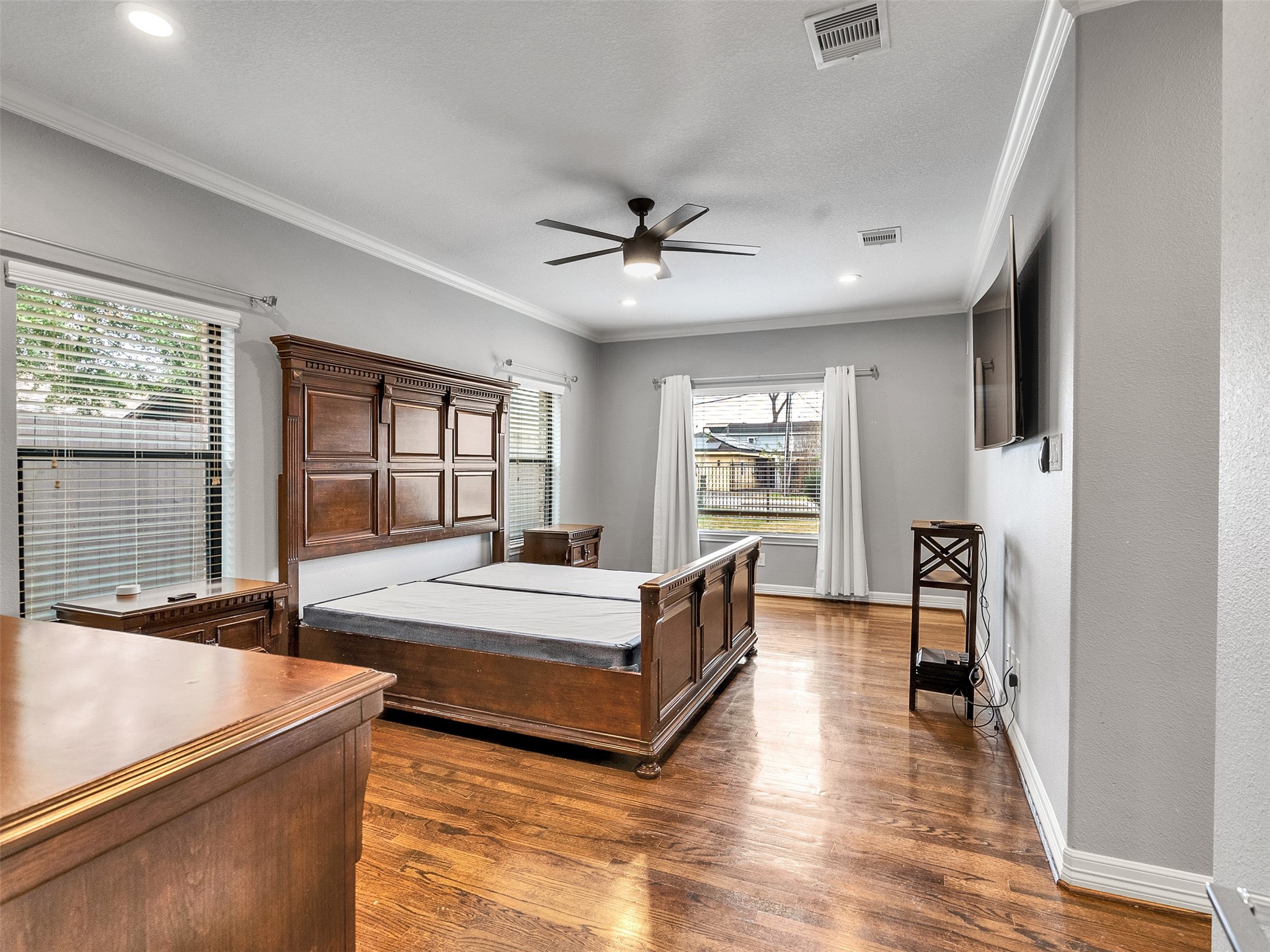5814 Luna Street Houston, TX 77076 - Photo 21 of 44 a spacious bedroom with a bed and wooden floor