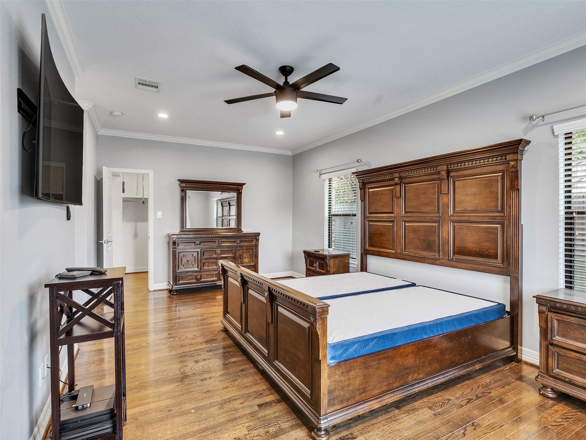 5814 Luna Street Houston, TX 77076 - Photo 22 of 44 a bedroom with a bed and a flat screen tv