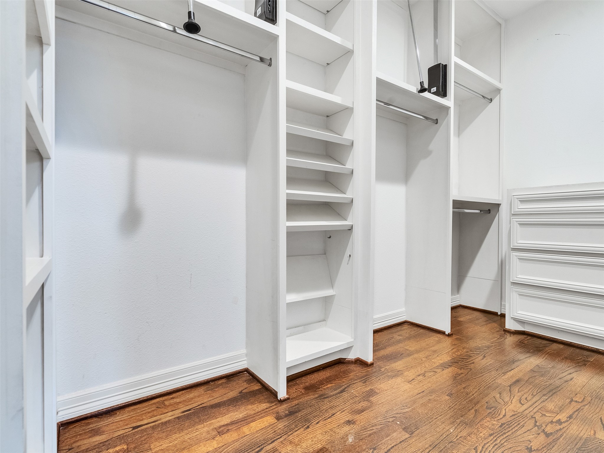 5814 Luna Street Houston, TX 77076 - Photo 24 of 44 a view of walk in closet with empty racks
