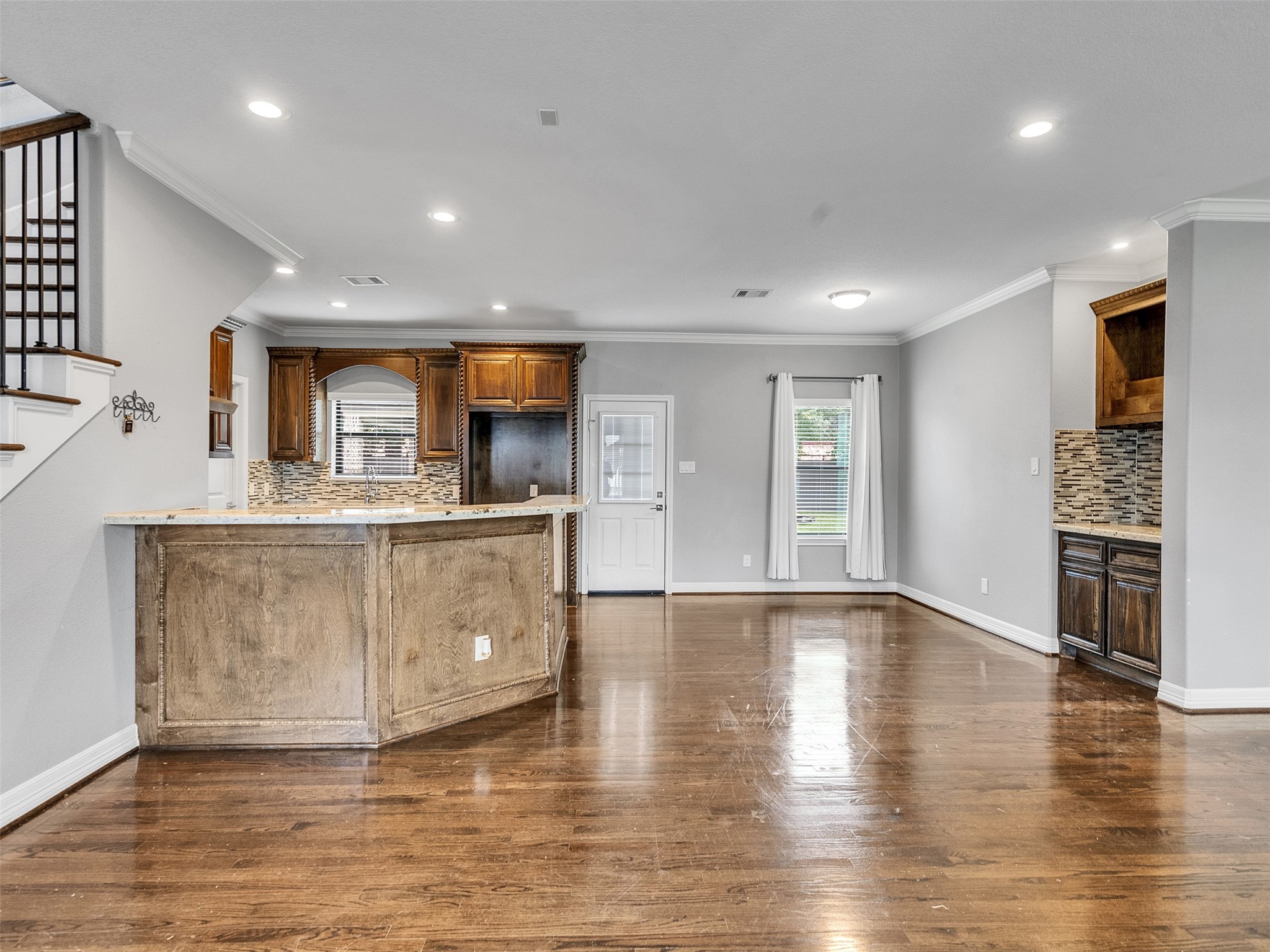5814 Luna Street Houston, TX 77076 - Photo 7 of 44 a view of kitchen with cabinets and wooden floor