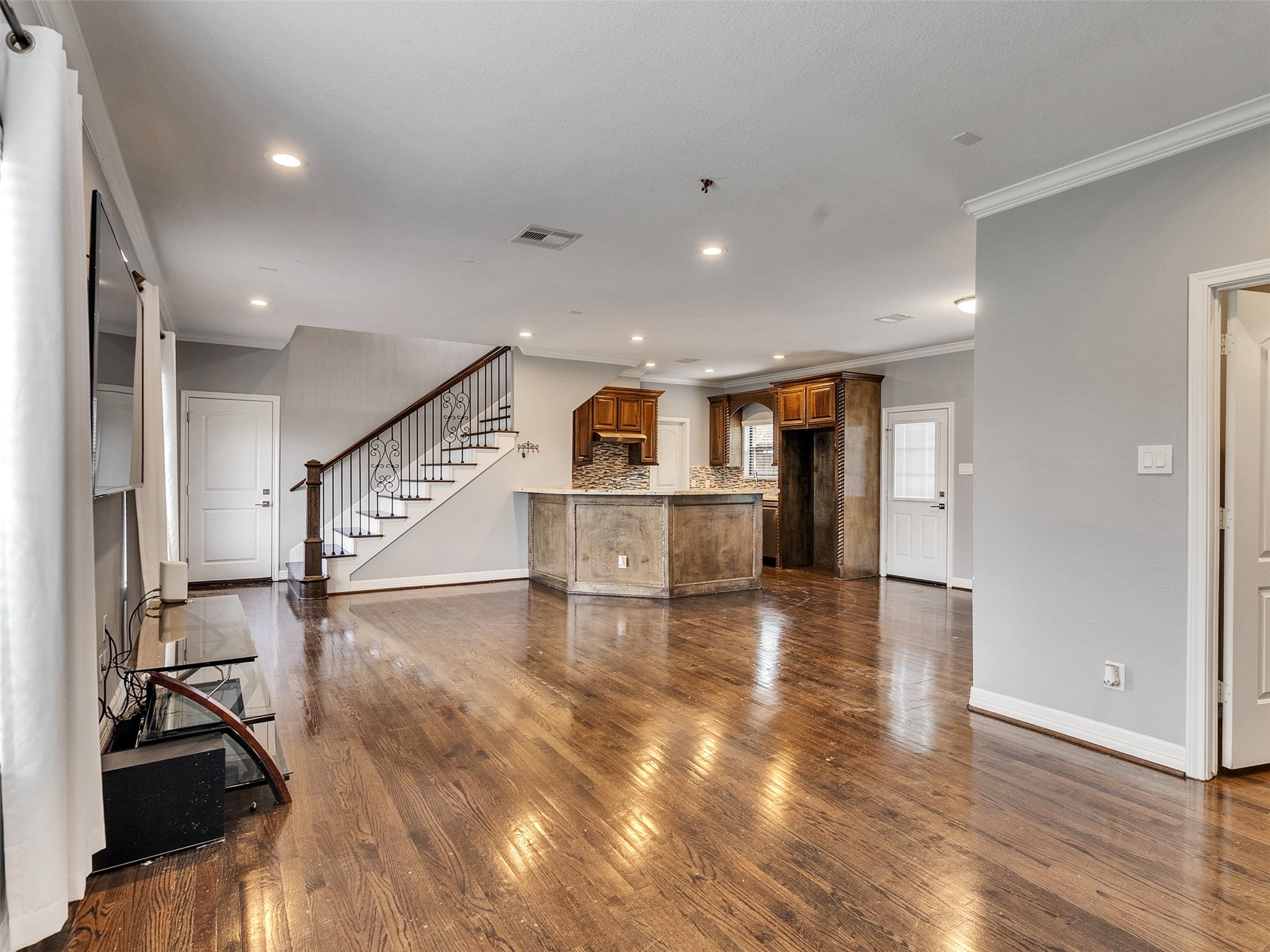 5814 Luna Street Houston, TX 77076 - Photo 9 of 44 a view of a livingroom with wooden floor and stairs