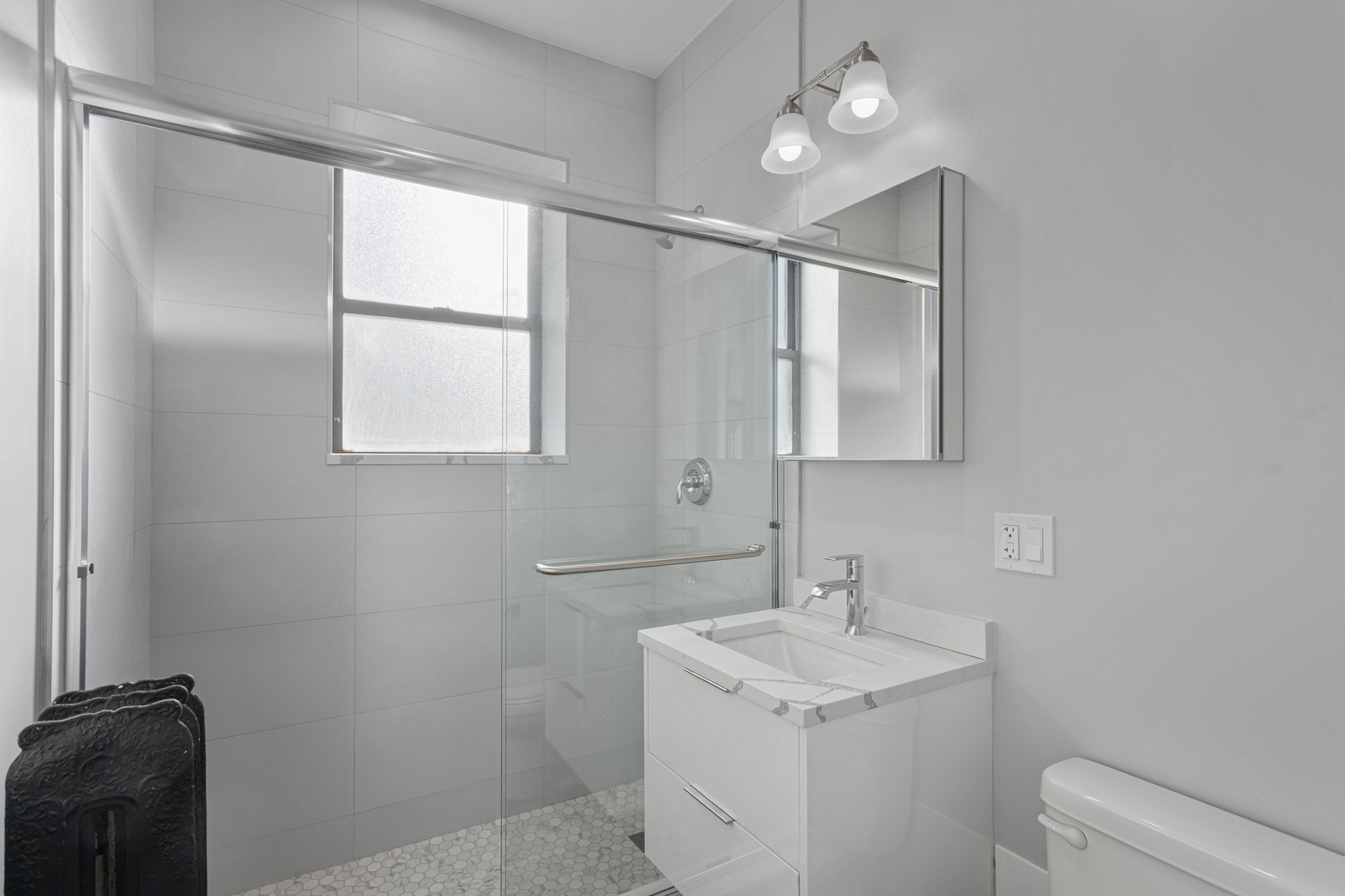6929 North Lakewood Avenue, Unit 2 Chicago, IL 60626 - Photo 12 of 13 a bathroom with a granite countertop sink toilet and mirror
