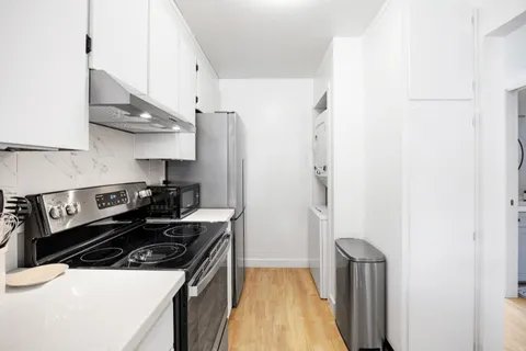 a kitchen with a stove and a refrigerator