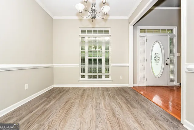 a view of a room with wooden floor and windows