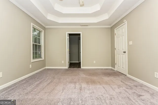 an empty room with windows and closet