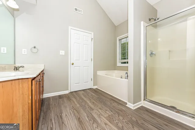 a bathroom with a tub shower and sink