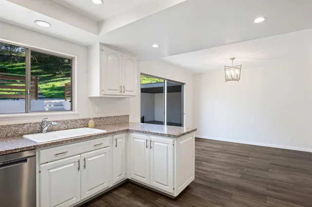 a kitchen with a sink cabinets and window