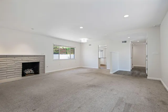 a view of empty room with a fireplace