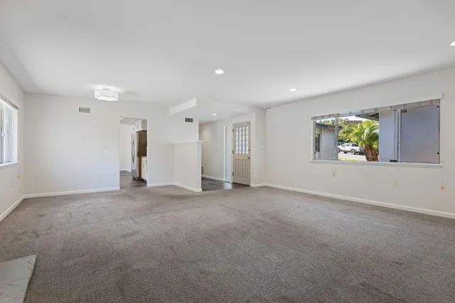 an empty room with windows and natural light