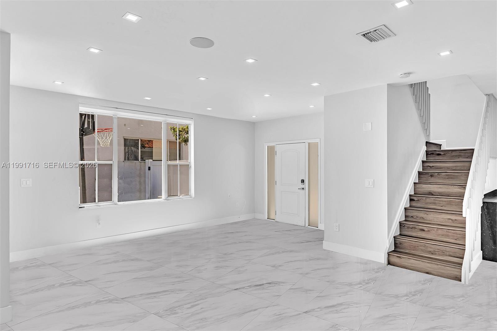 3085 North 36th Avenue Hollywood, FL 33021 - Photo 13 of 76 an empty room with wooden floor and windows