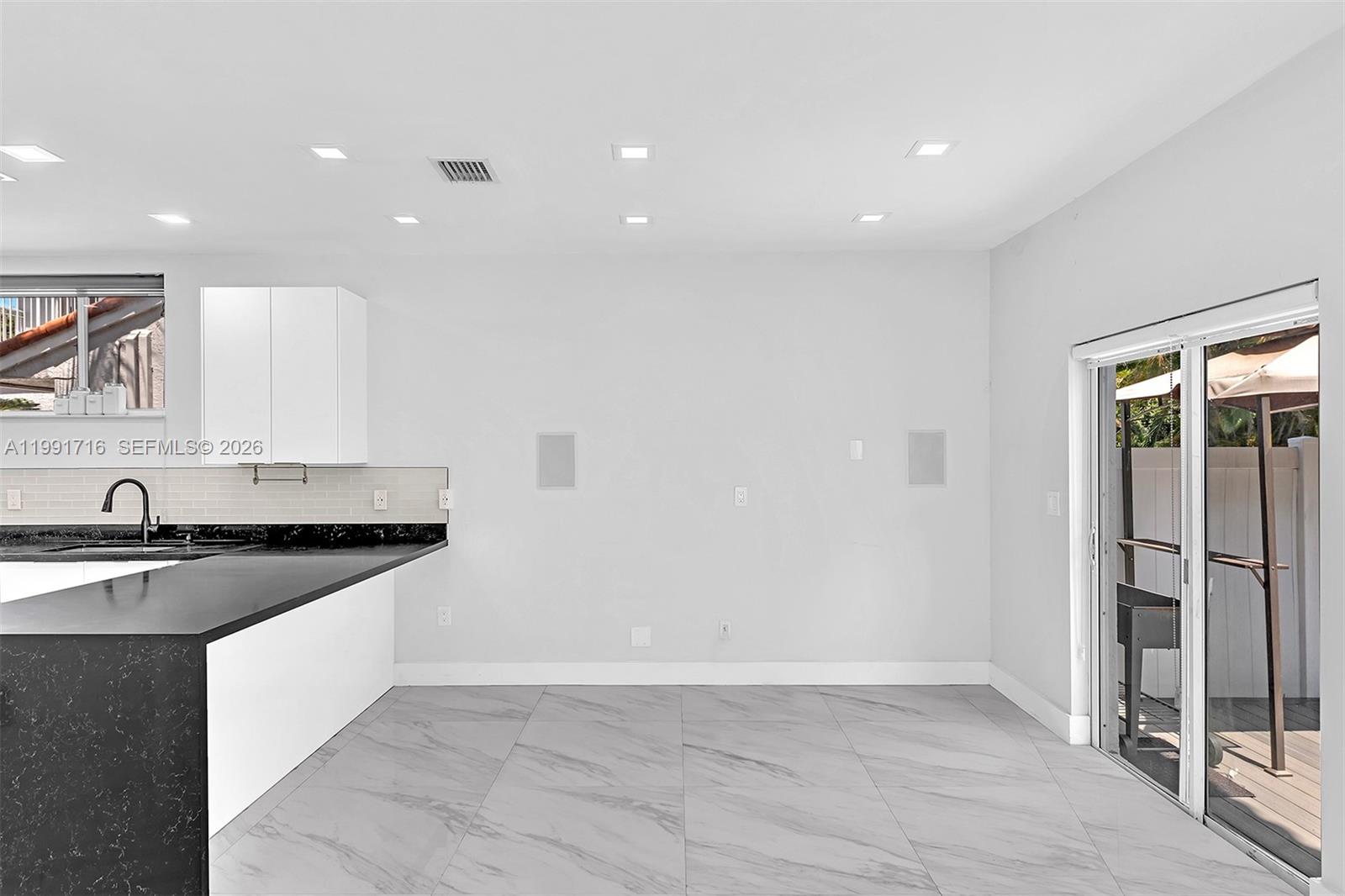 3085 North 36th Avenue Hollywood, FL 33021 - Photo 15 of 76 a kitchen with granite countertop a sink and a stove top oven