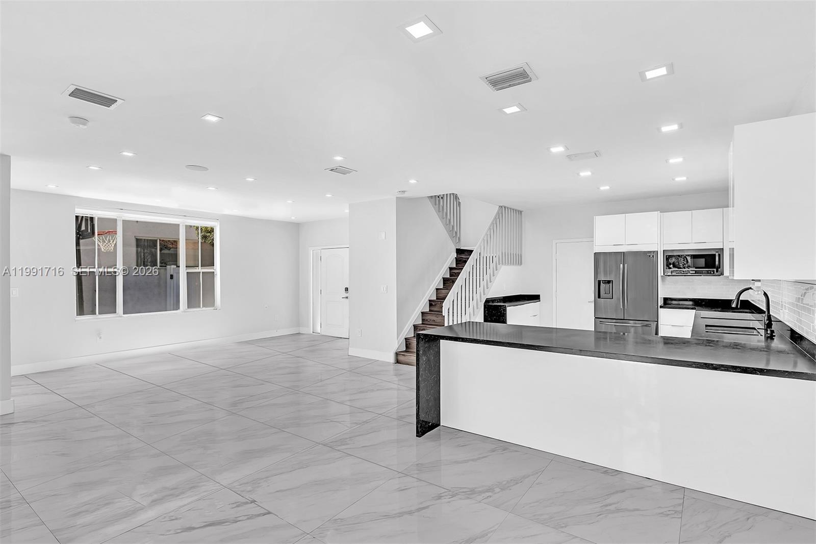 3085 North 36th Avenue Hollywood, FL 33021 - Photo 20 of 76 a view of a kitchen with kitchen island a sink a counter top space and stainless steel appliances
