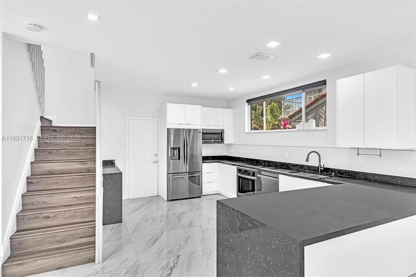 3085 North 36th Avenue Hollywood, FL 33021 - Photo 22 of 76 a kitchen with a refrigerator and a sink