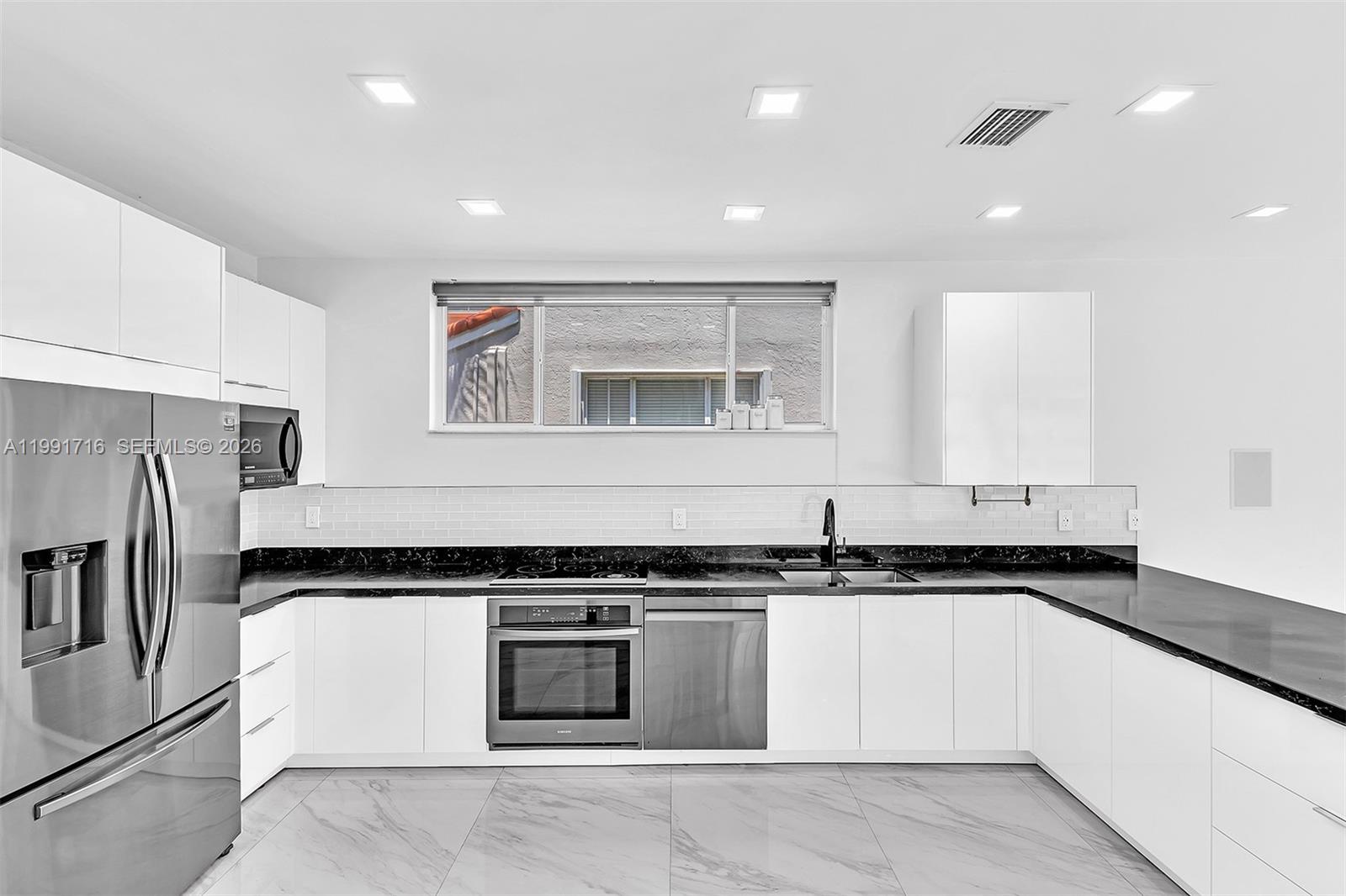 3085 North 36th Avenue Hollywood, FL 33021 - Photo 23 of 76 a kitchen with granite countertop a refrigerator and a sink