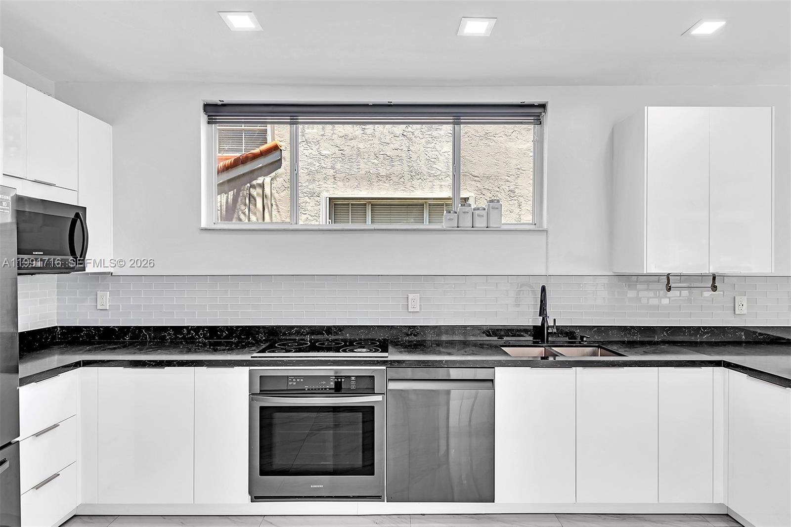 3085 North 36th Avenue Hollywood, FL 33021 - Photo 24 of 76 a kitchen with granite countertop a stove a sink and a granite counter tops