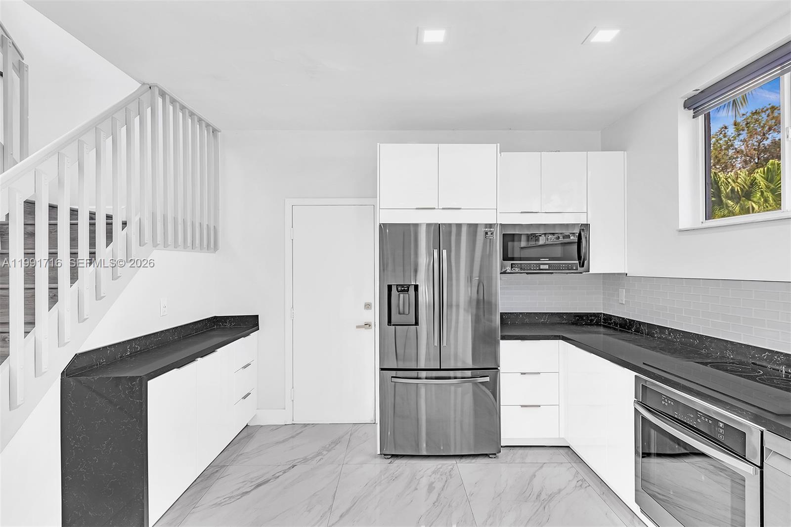 3085 North 36th Avenue Hollywood, FL 33021 - Photo 25 of 76 a kitchen with a refrigerator and a stove top oven