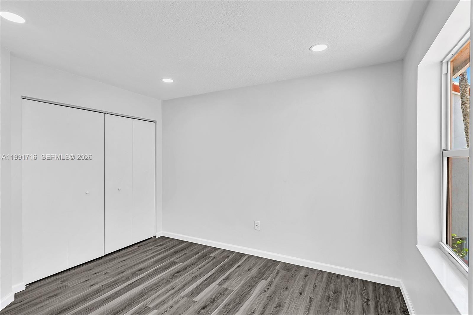 3085 North 36th Avenue Hollywood, FL 33021 - Photo 30 of 76 a view of an empty room with wooden floor and a window