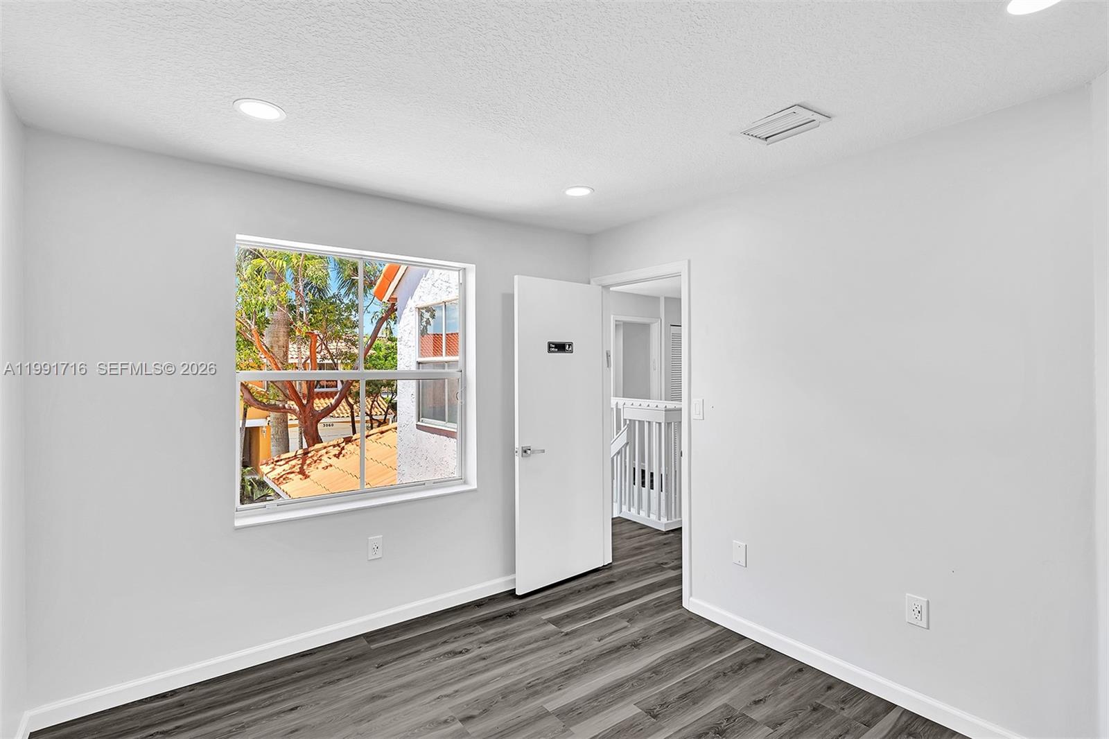 3085 North 36th Avenue Hollywood, FL 33021 - Photo 31 of 76 a view of an empty room with wooden floor and a window