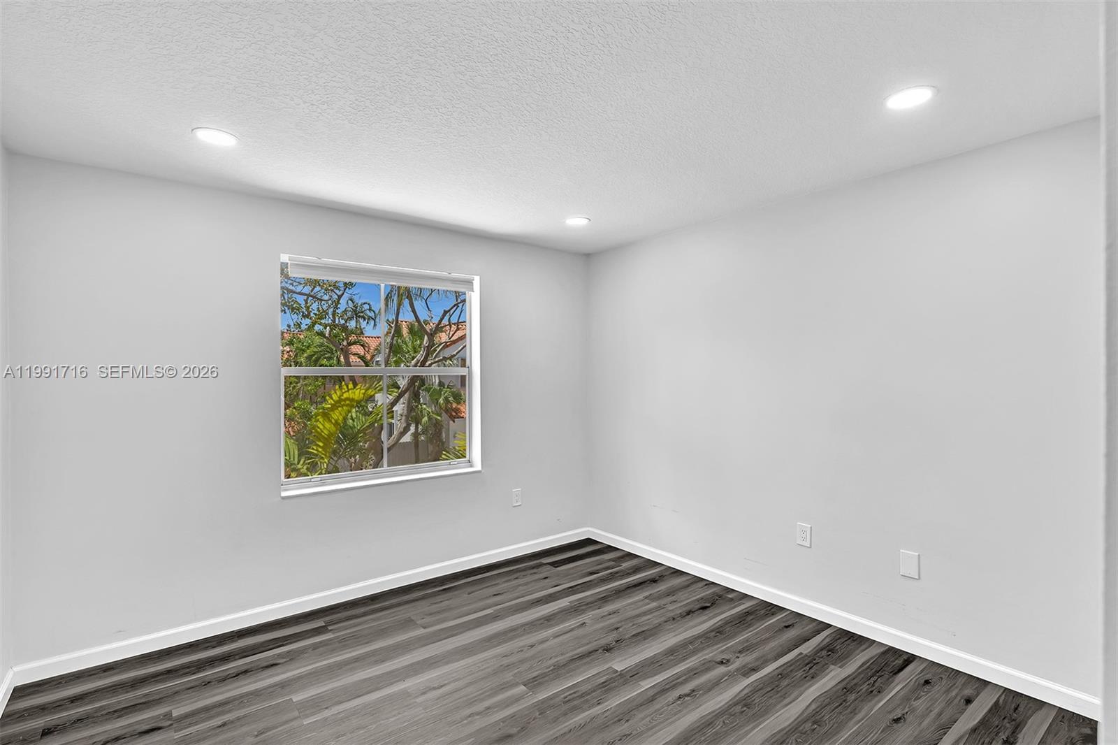 3085 North 36th Avenue Hollywood, FL 33021 - Photo 33 of 76 a view of an empty room with wooden floor and a window